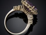 an amethorate and diamond ring on a black surface