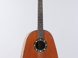 an image of a guitar hanging from a string on a wall