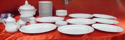 many plates and cups on a table with a red table cloth