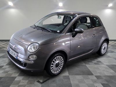 a picture of a small grey car parked in a garage