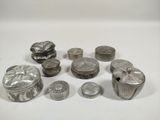 some silver objects are sitting on a white surface