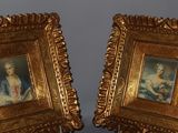 pair of gold framed paintings of a woman and a child