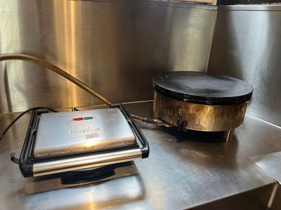 a waffle maker sitting on a counter in a commercial kitchen