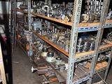 many shelves with various metal items on them in a room