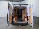 a white van with open doors inside of a building
