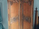a large wooden cabinet in the corner of a room