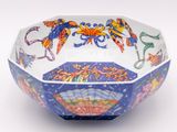 a blue and white bowl with colorful designs on it