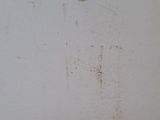 a picture of a dirty wall with a sign on it