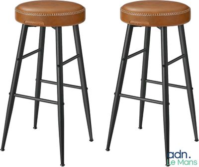une paire de tabourets en cuir marron avec des pieds en métal