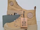 the boots are tan in color and have a tag on them