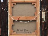 an old picture frame with a red bird on it
