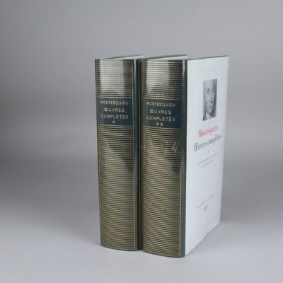 two books sitting on top of each other in front of a gray background