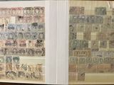 two pages with stamps on them on a table