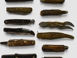 many different types of pocket knives on a white surface
