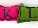 deux oreillers sur lesquels figurent les lettres « kl » et « l »