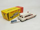 a white toy car and a box with a red and white car
