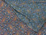a close up of a blue and red paisley print fabric