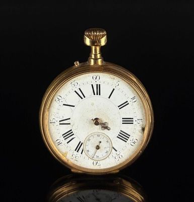 an old gold pocket watch with roman numerals and roman numerals on the face