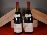 two bottles of wine sitting next to each other on a table
