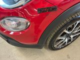 a close up of a red car with a sticker on it