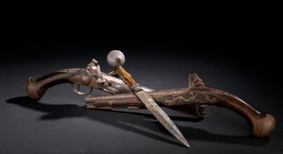 une image représentant une paire de pistolets et un couteau sur fond noir
