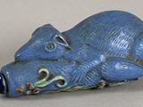 a small blue animal figurine sitting on a table