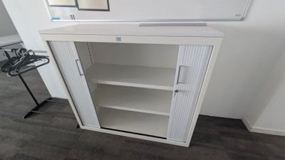 a white cabinet with a mirror on top of it