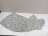 a piece of silver sequin on a white table