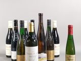 several bottles of wine are lined up in a row on a table