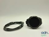 a close up of a watch on a white surface with a cord