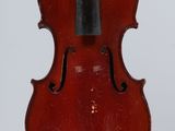 a red violin with a black bow hanging from it ' s back
