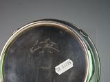 a close up of a silver vase with a label on it