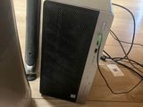 a small computer on the floor next to a speaker
