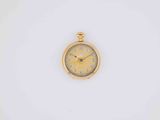 a close up of a gold watch on a white surface