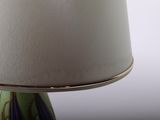 a close up of a lamp with a white shade on it