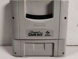 an old nintendo gameboy sitting on top of a white table