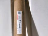 a roll of brown paper on a white surface