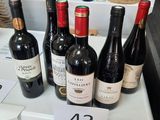 many bottles of wine sitting on a shelf in a store