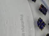 a group of blue and gold rings sitting on a white surface