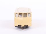 a toy bus that is sitting on a white surface