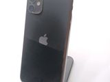 a black iphone sitting on a stand on a white surface