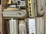 a cardboard box filled with different types of toy trains