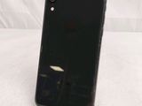 the back of a black iphone xr phone sitting on top of a table