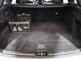 a trunk of a car with a basket of flowers in it