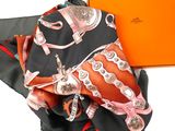 an orange box with a scarf and a black and red scarf