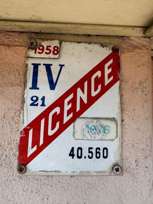 a red and white sign on the side of a building