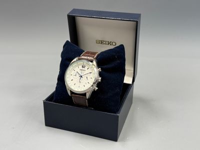 seiko watch in a box with a blue bow tie