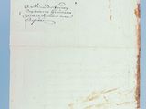 an old piece of paper with writing on it sitting on top of a table