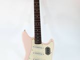 pink electric guitar on stand against a white background
