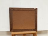 an old wooden easel with a brown canvas on it